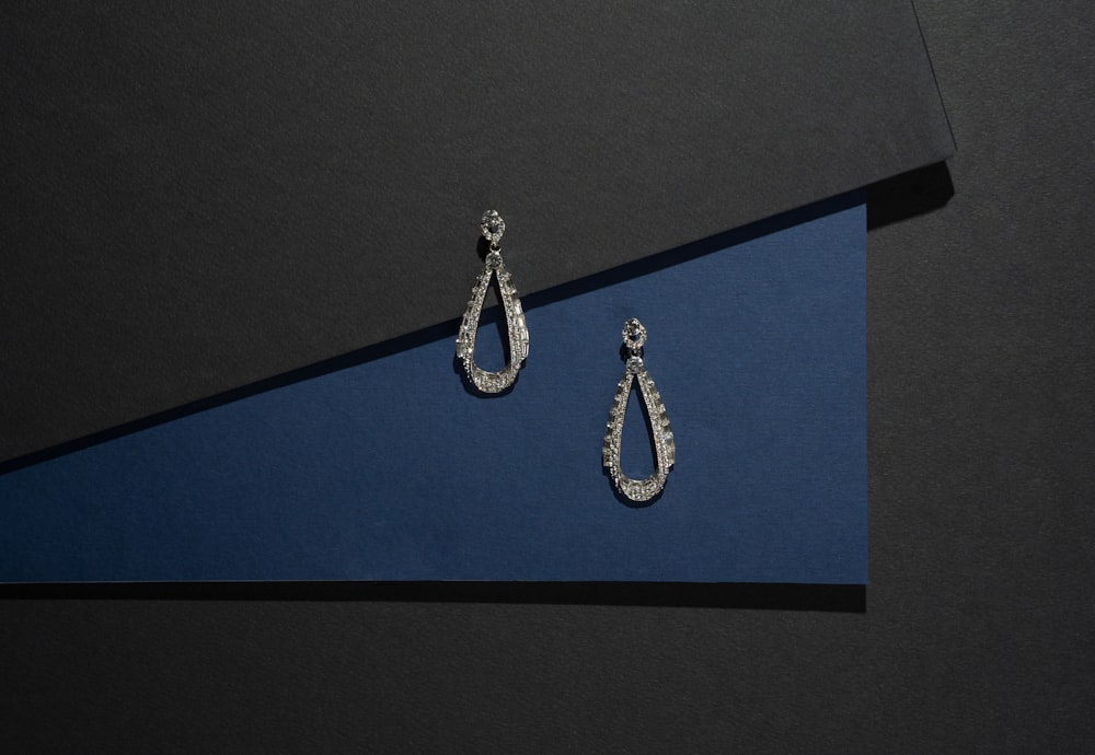 a pair of earrings on a blue box