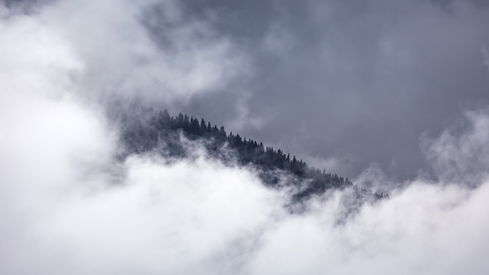 a person riding a wave on a cloudy day