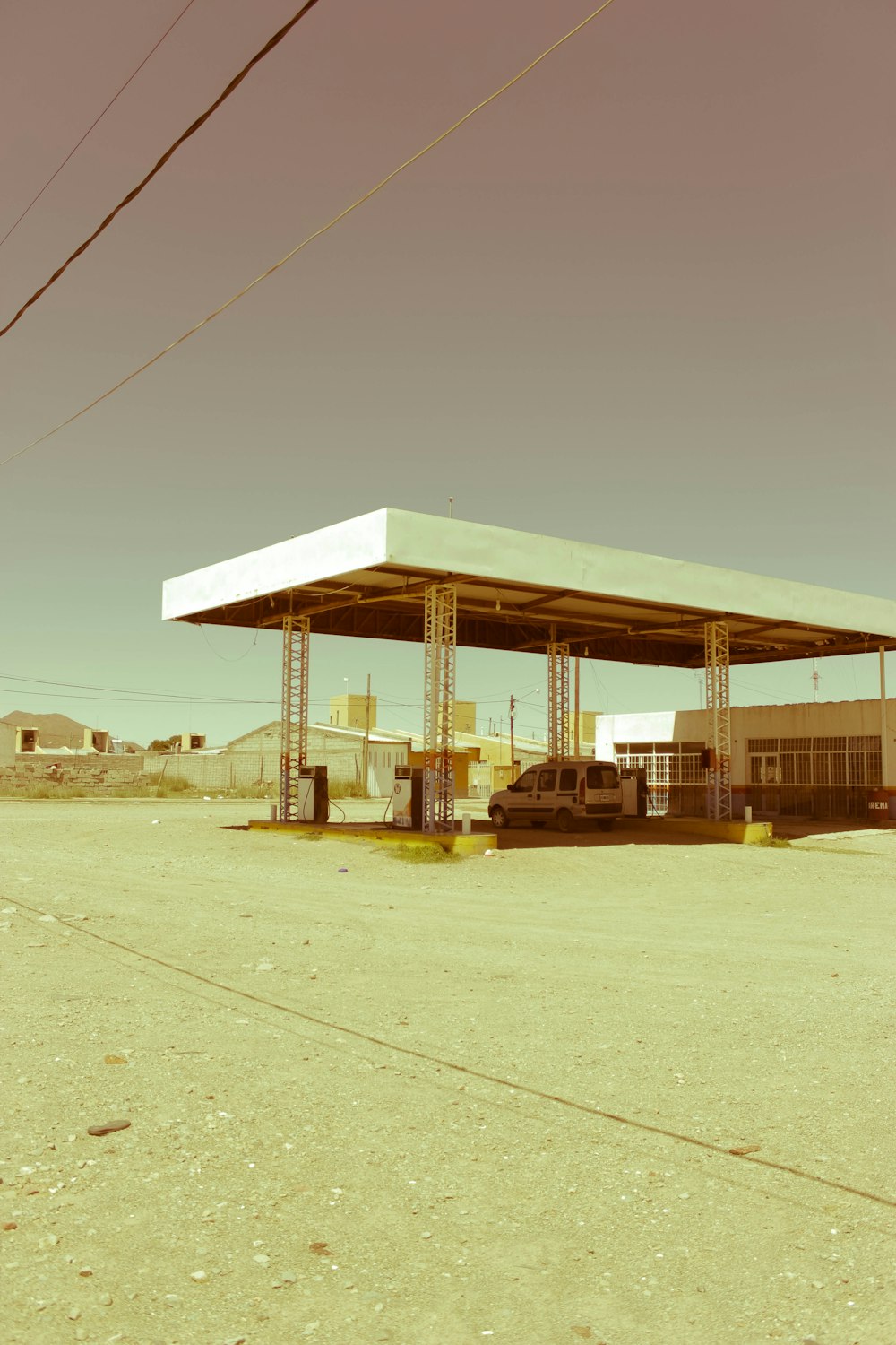 a structure outside with a car in the front