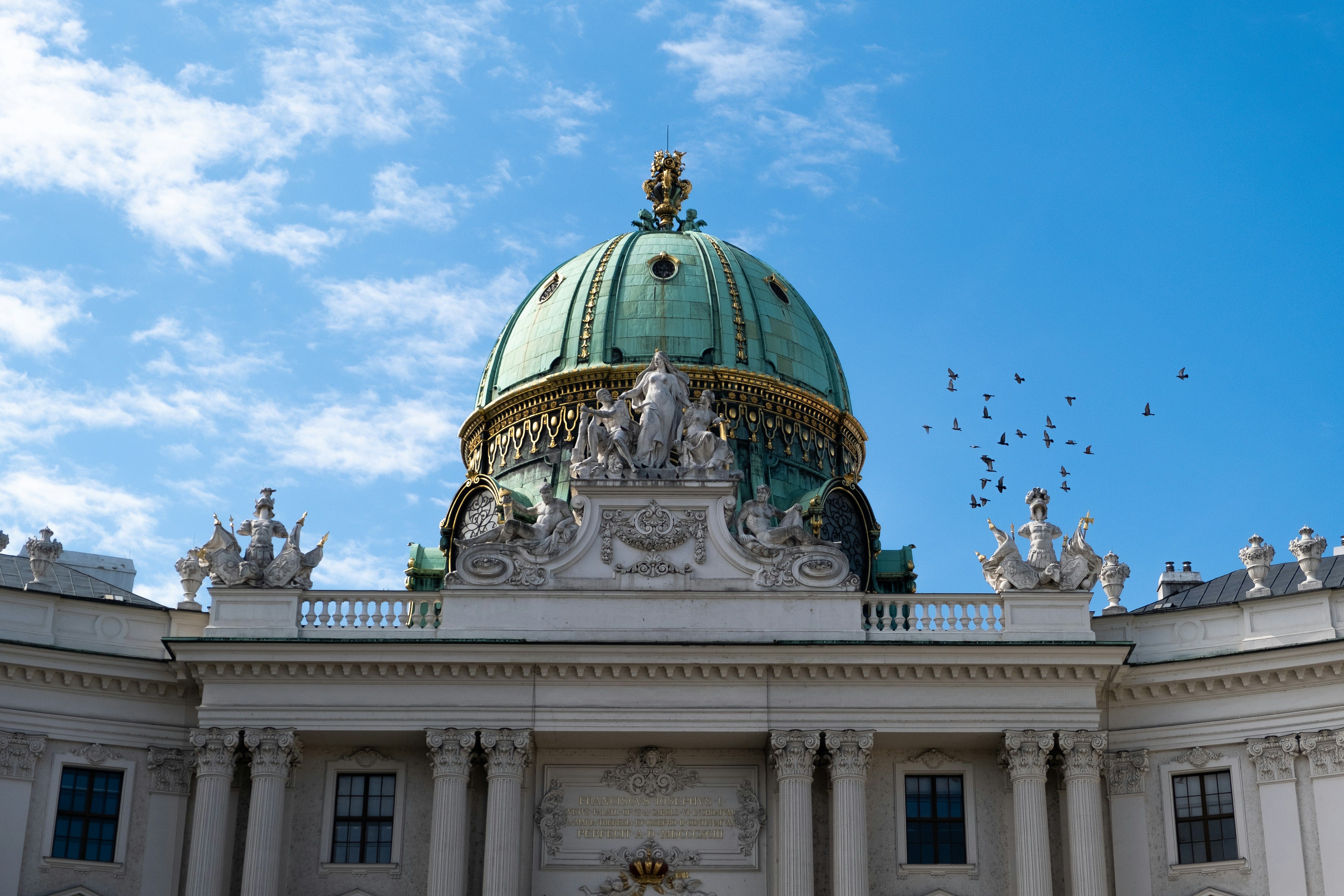 a building with a dome and statues