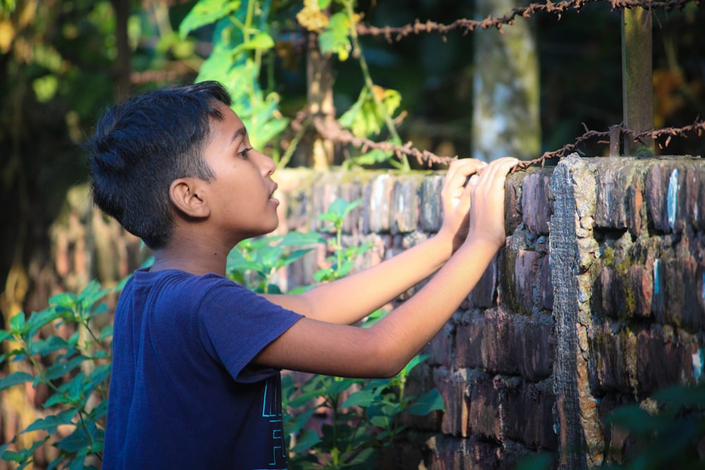 a boy holding a tree branch