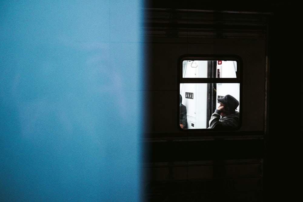 a person taking a picture of himself in a window