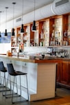 a bar with a large bar and many bottles of alcohol