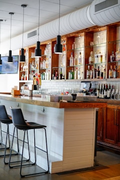 a bar with a large bar and many bottles of alcohol