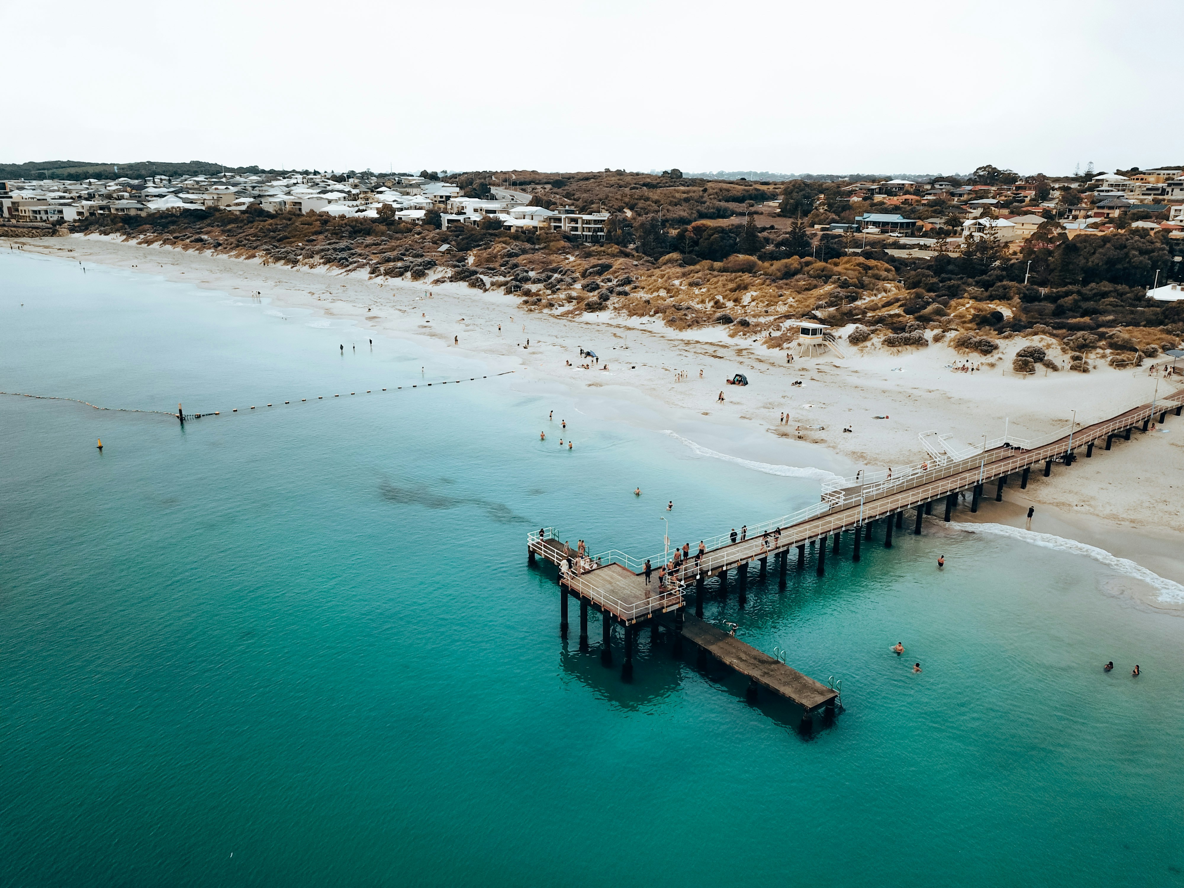 a beach with a pier and a body of water