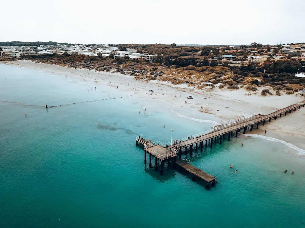a beach with a pier and a body of water