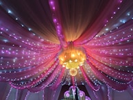 Soft pink and gold draped fabrics creating a mystical backdrop for a spiritual session.