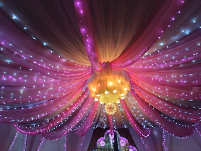 Elegant event lighting casting warm gold and electric blue hues over a dance floor.