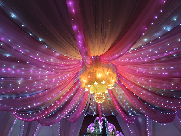 Evening celebration with elegant lighting, pink and gold decorations highlighting the joyful atmosphere.