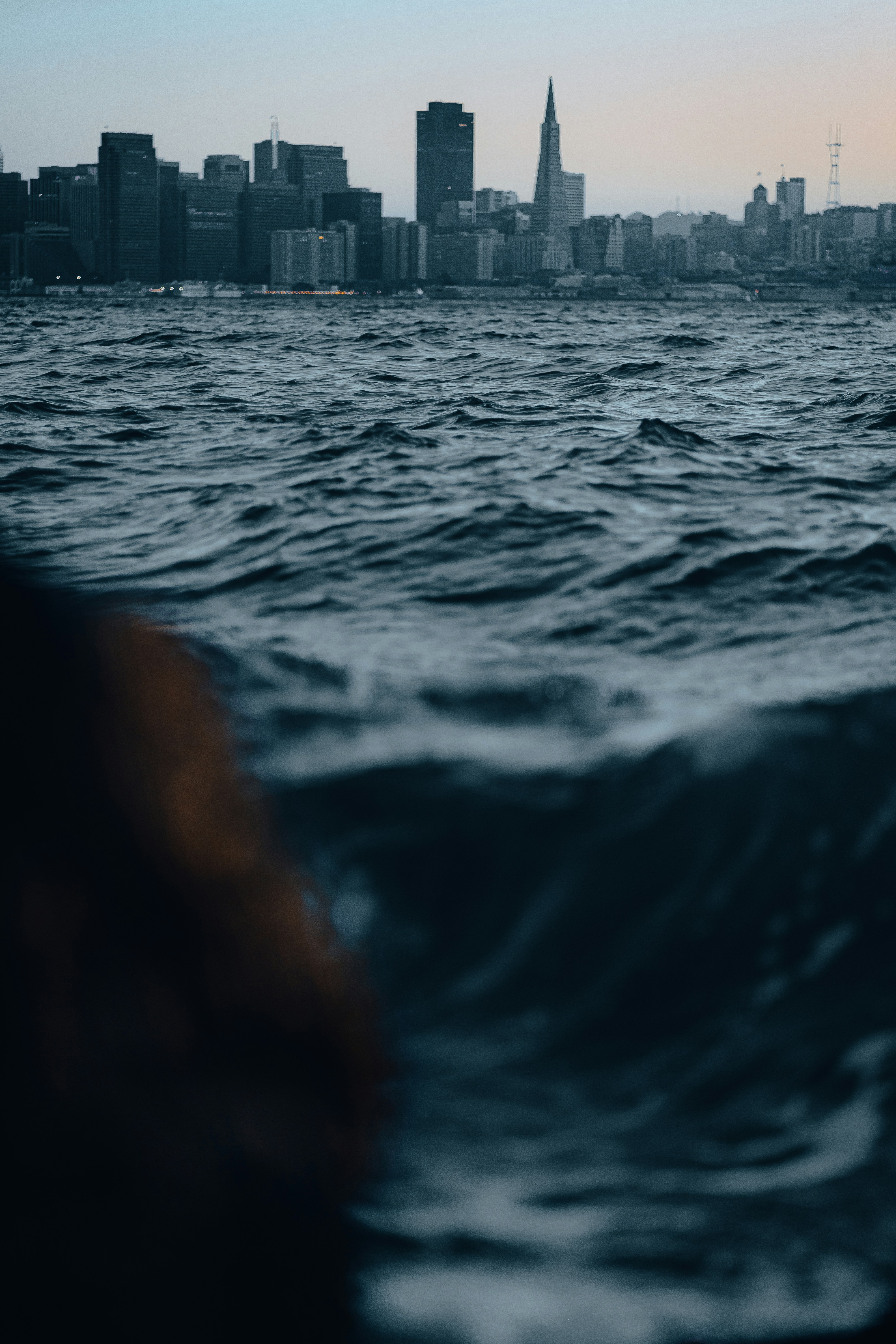 A city skyline seen from the water photo – Free Grey Image on Unsplash