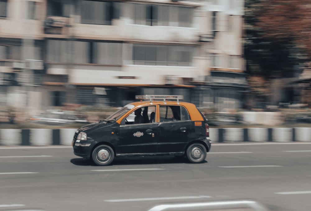 a small black car on a road