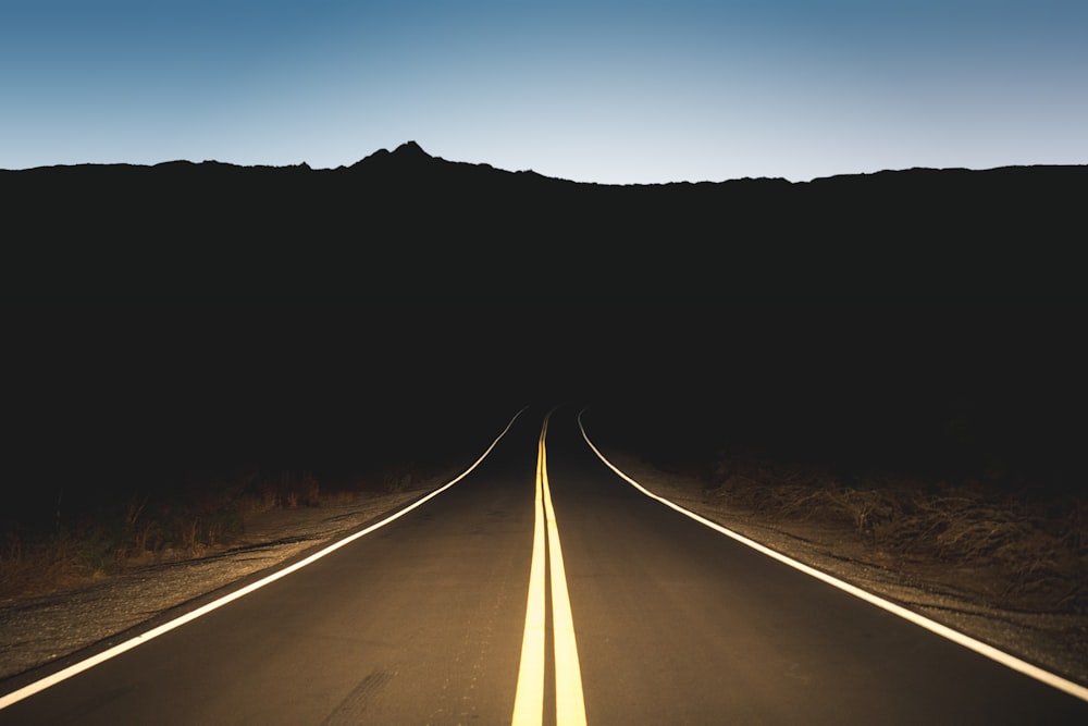 a long straight road with trees on either side of it