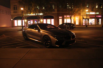 A sleek car parked safely on a quiet street, illustrating vehicle insurance coverage.