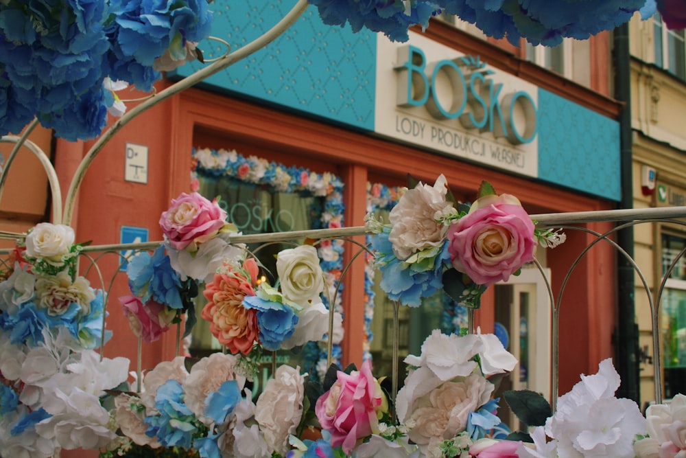 a group of flowers in front of a building