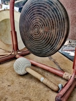 Close-up of a gong mallet striking, releasing waves of harmonic vibrations.