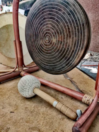 A large, shimmering gong hanging in a softly lit room, ready to create healing vibrations.