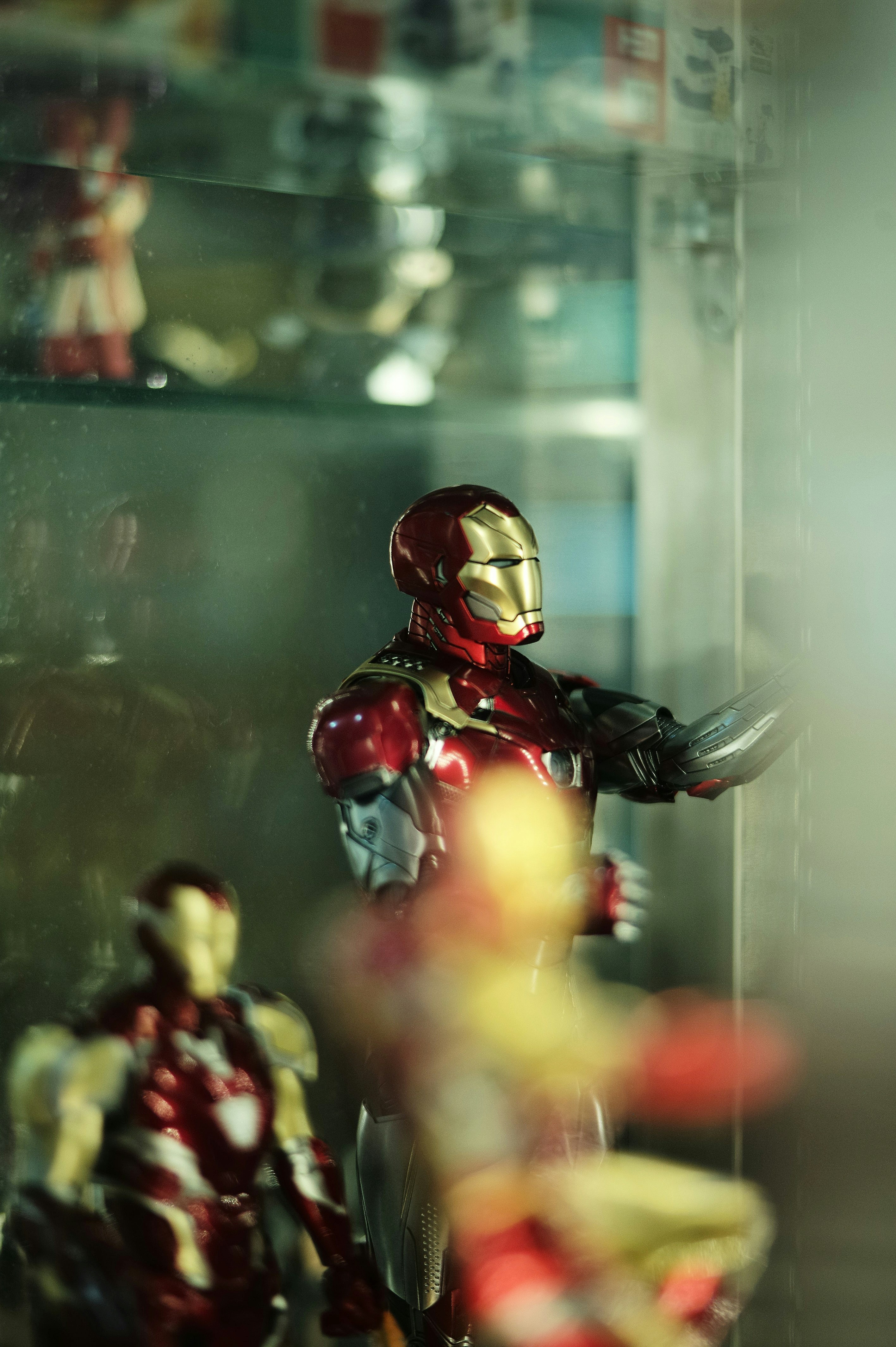Detailed Iron Man Mark 50 action figure in gold and red armor with articulated joints in dim atmospheric display