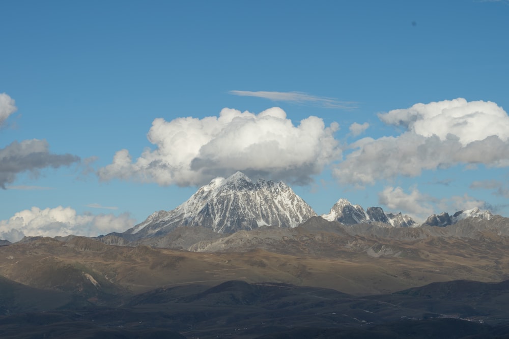 a mountain with clouds in the sky