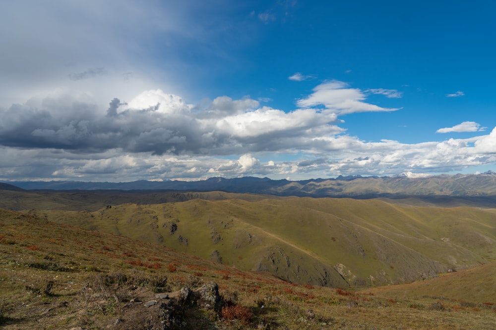 a landscape with hills and clouds