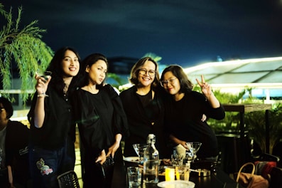 A group of friends enjoying a night out in stylish dresses.