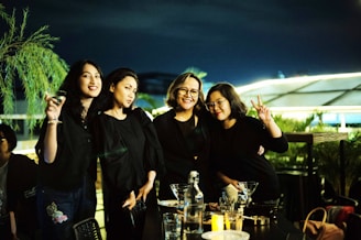 A group of friends enjoying a night out in stylish dresses.