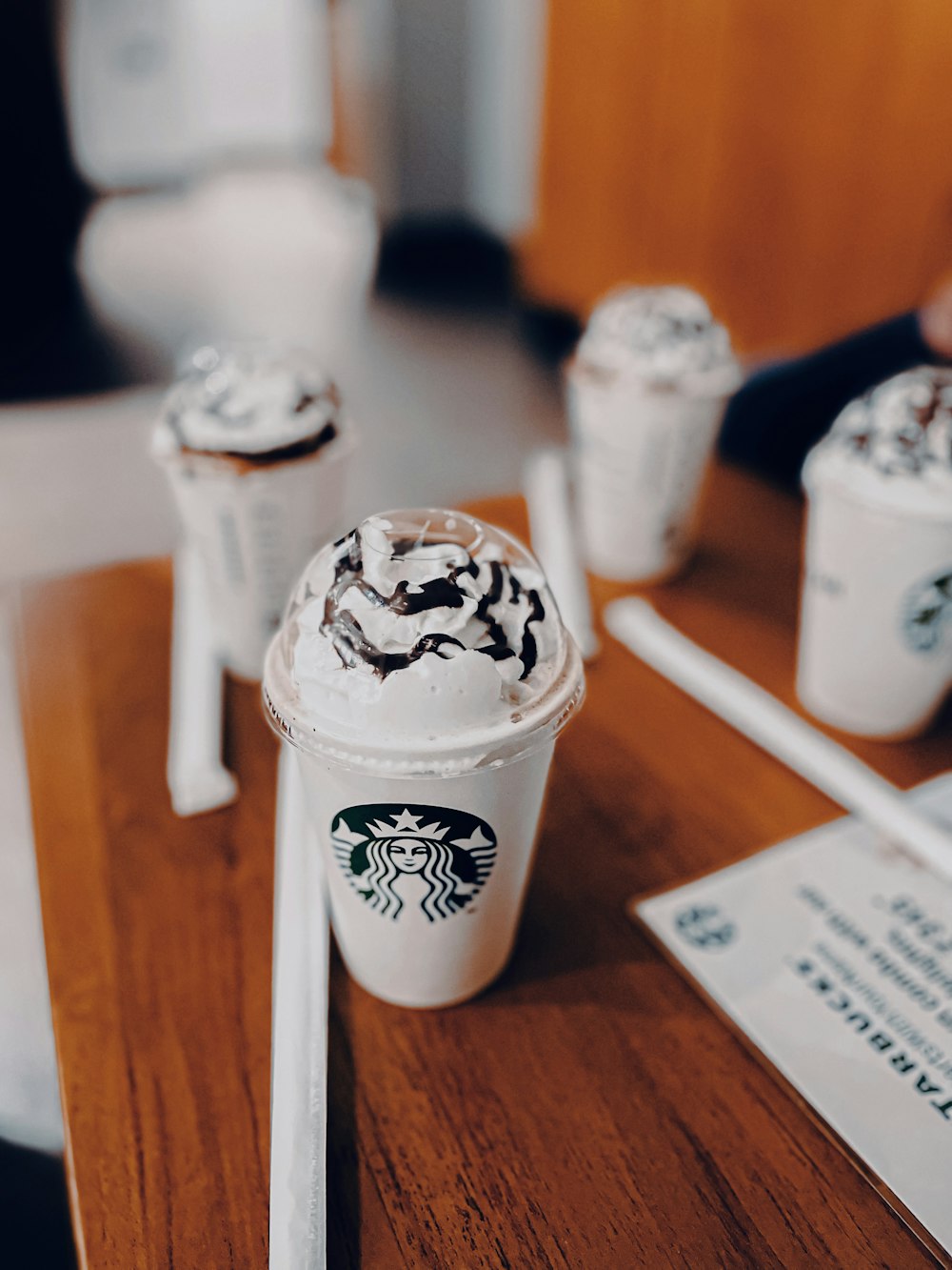 a cup with a lid and a straw on a table