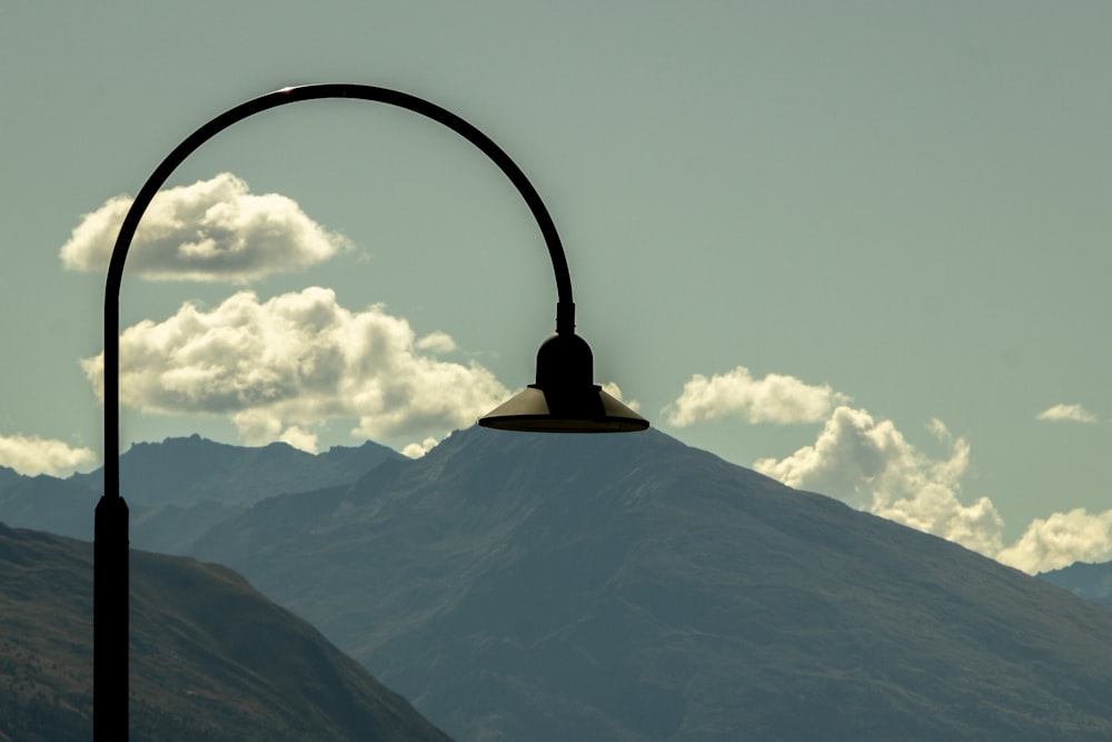 a light post with a mountain in the background