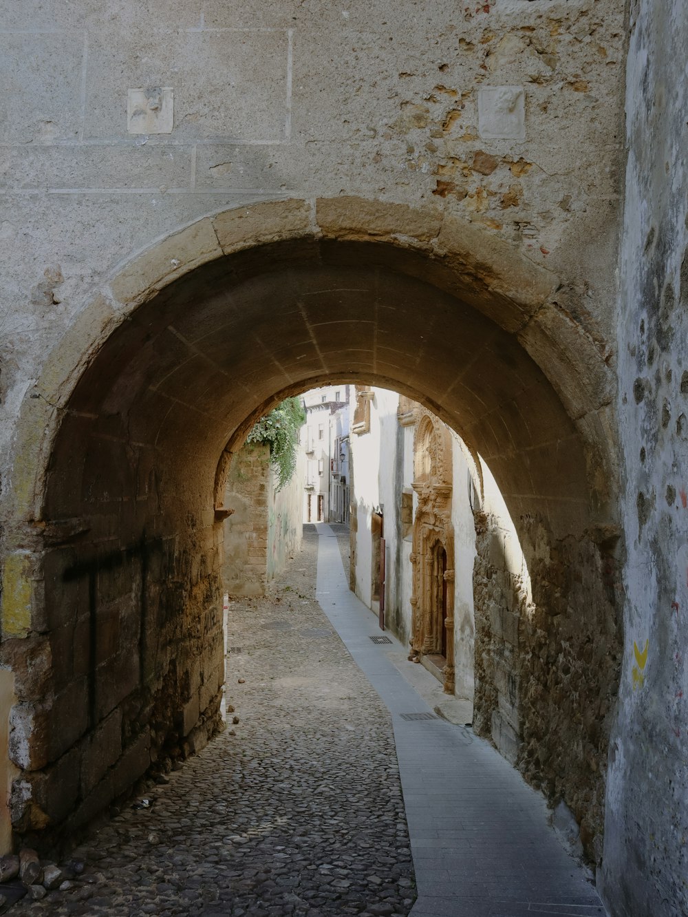 a stone walkway with arched supports