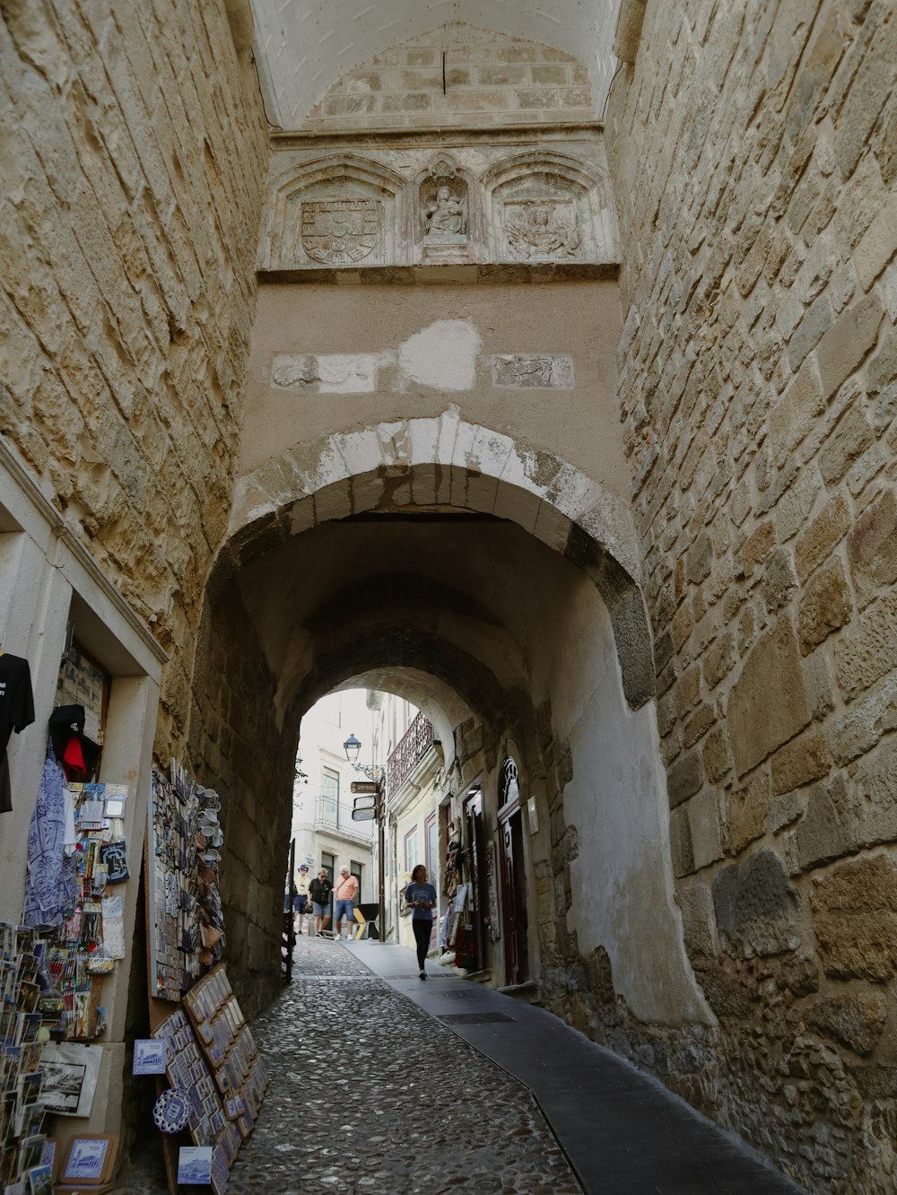 a stone walkway with people walking