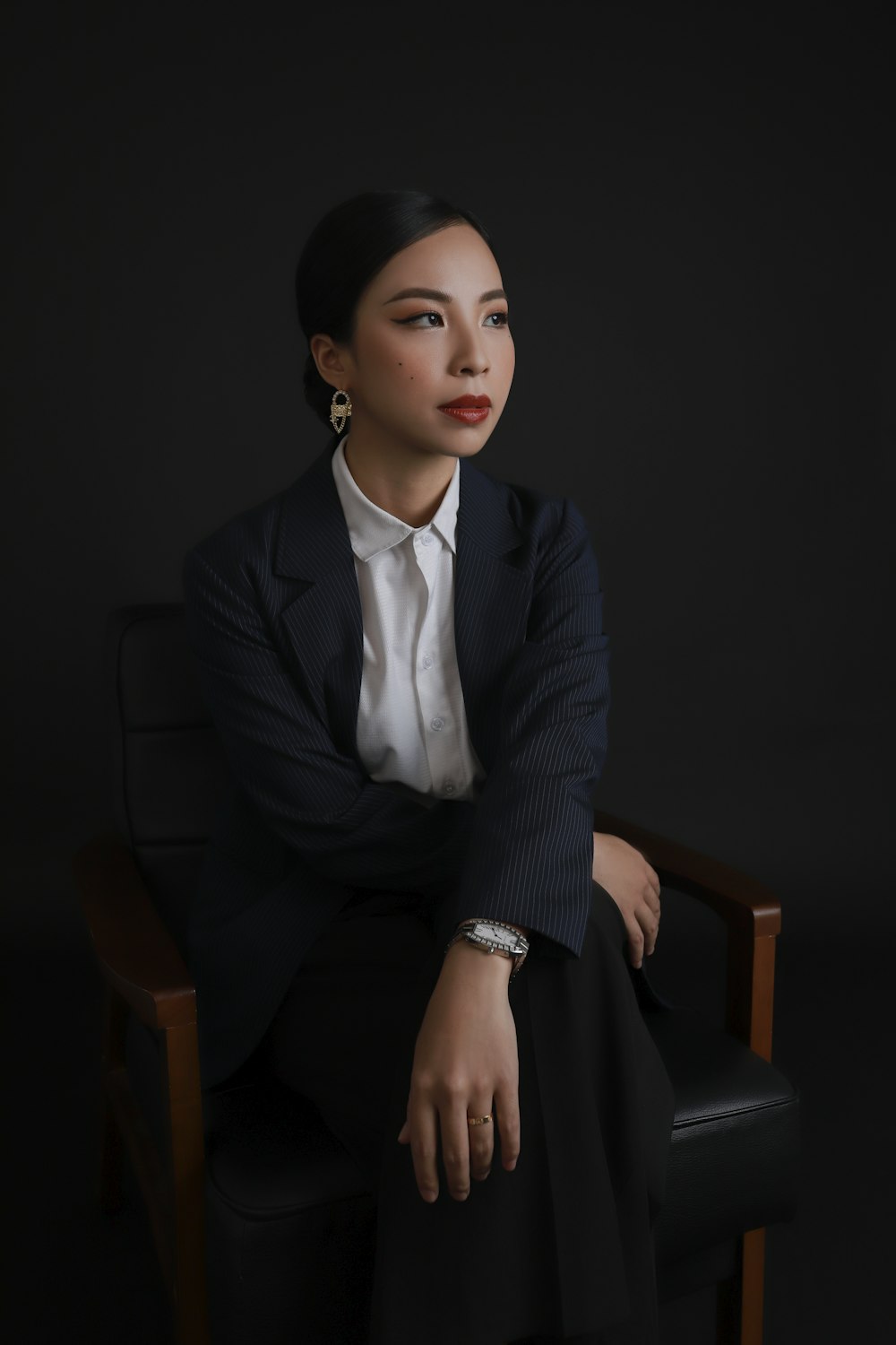 a person in a suit sitting in a chair