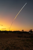 A breathtaking rocket launch captured against a sunset sky.
