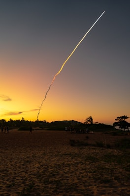 A missile launch captured mid-air against a backdrop of a cloudy sky.