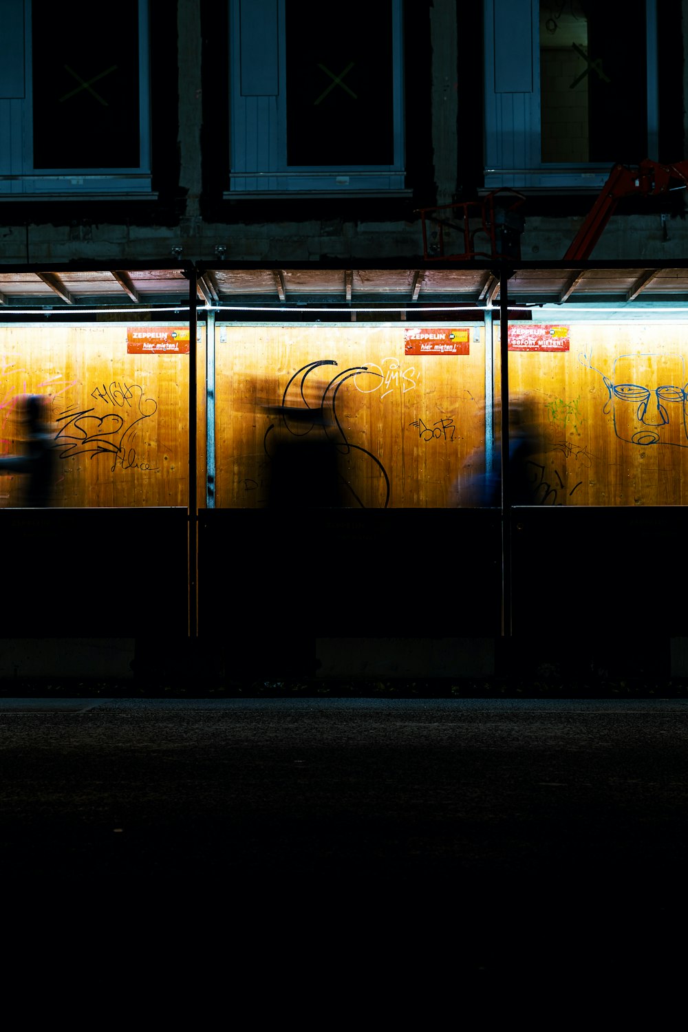 a person standing in front of a building with graffiti on it