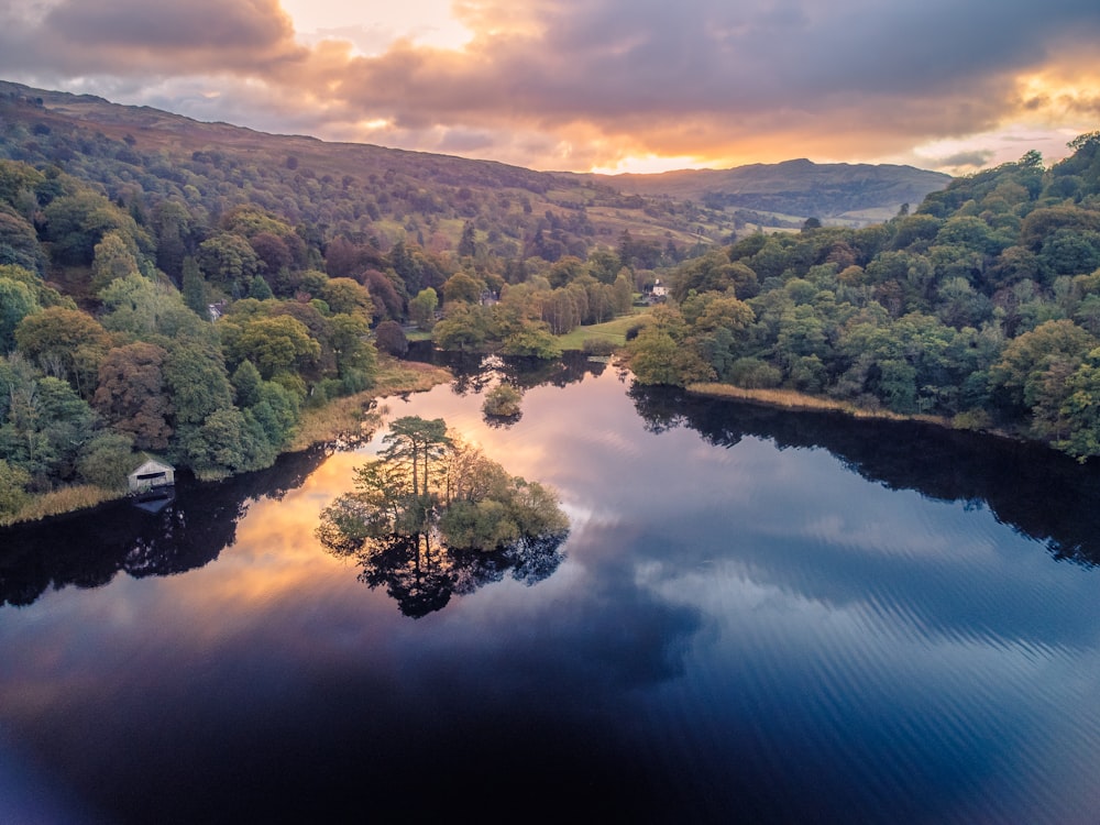 a lake surrounded by trees and hills