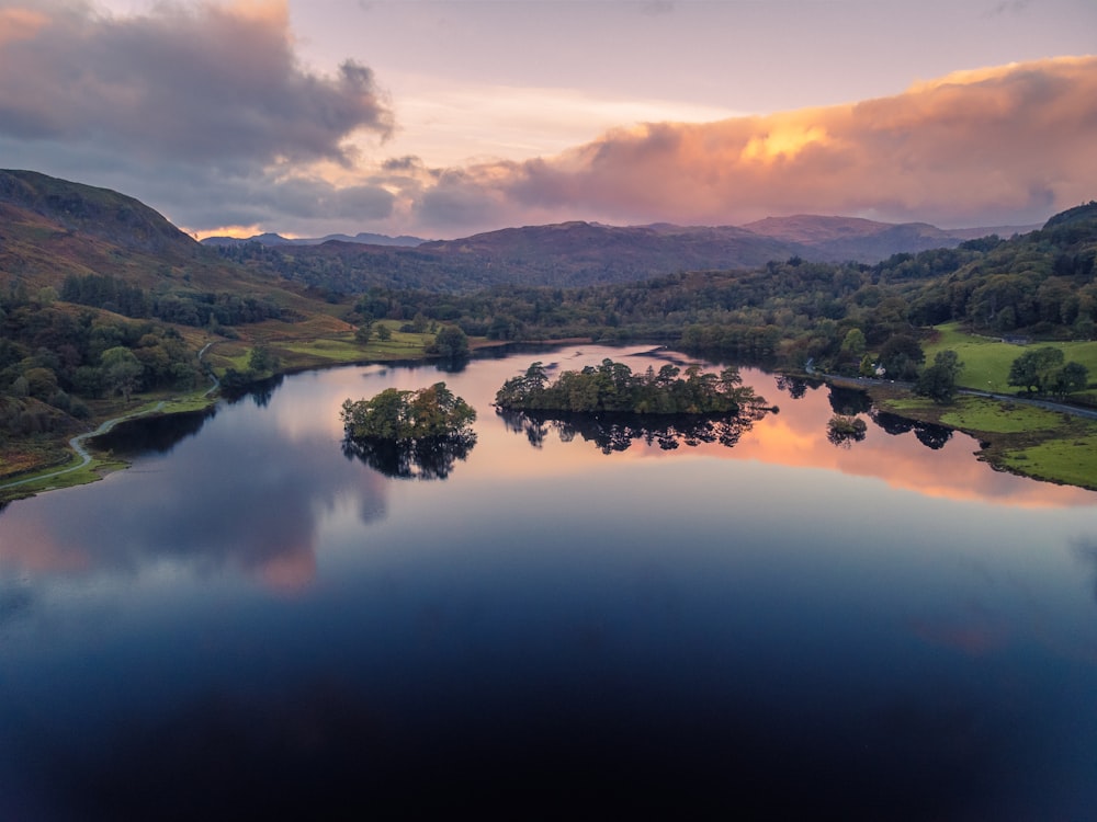 a lake surrounded by hills and trees