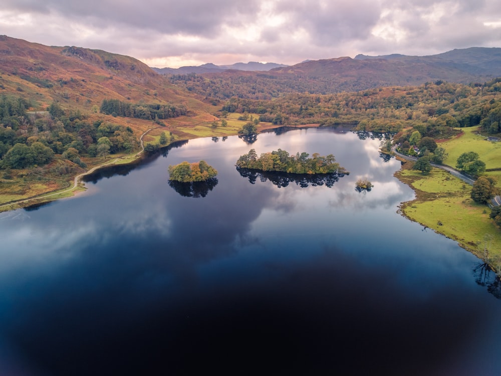 a lake surrounded by hills and trees