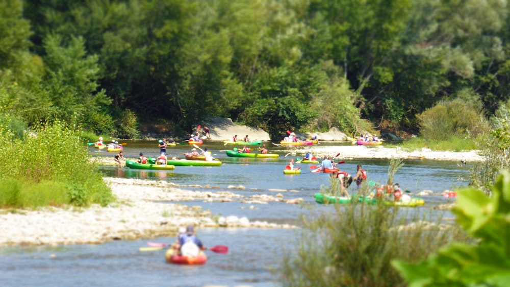 a group of people in kayaks on a river