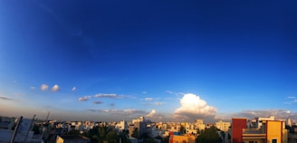 A vibrant panoramic view of Cotabato City’s bustling streets and cultural landmarks under a clear blue sky.