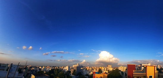 A vibrant panoramic view of Cotabato City’s bustling streets and cultural landmarks under a clear blue sky.