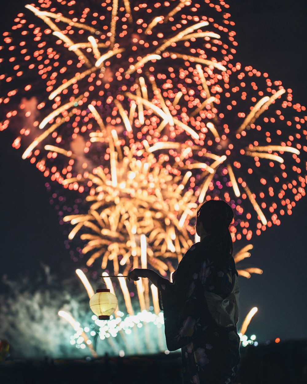 a person standing in front of a firework display
