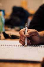 A close-up of a pen and notepad for writing.