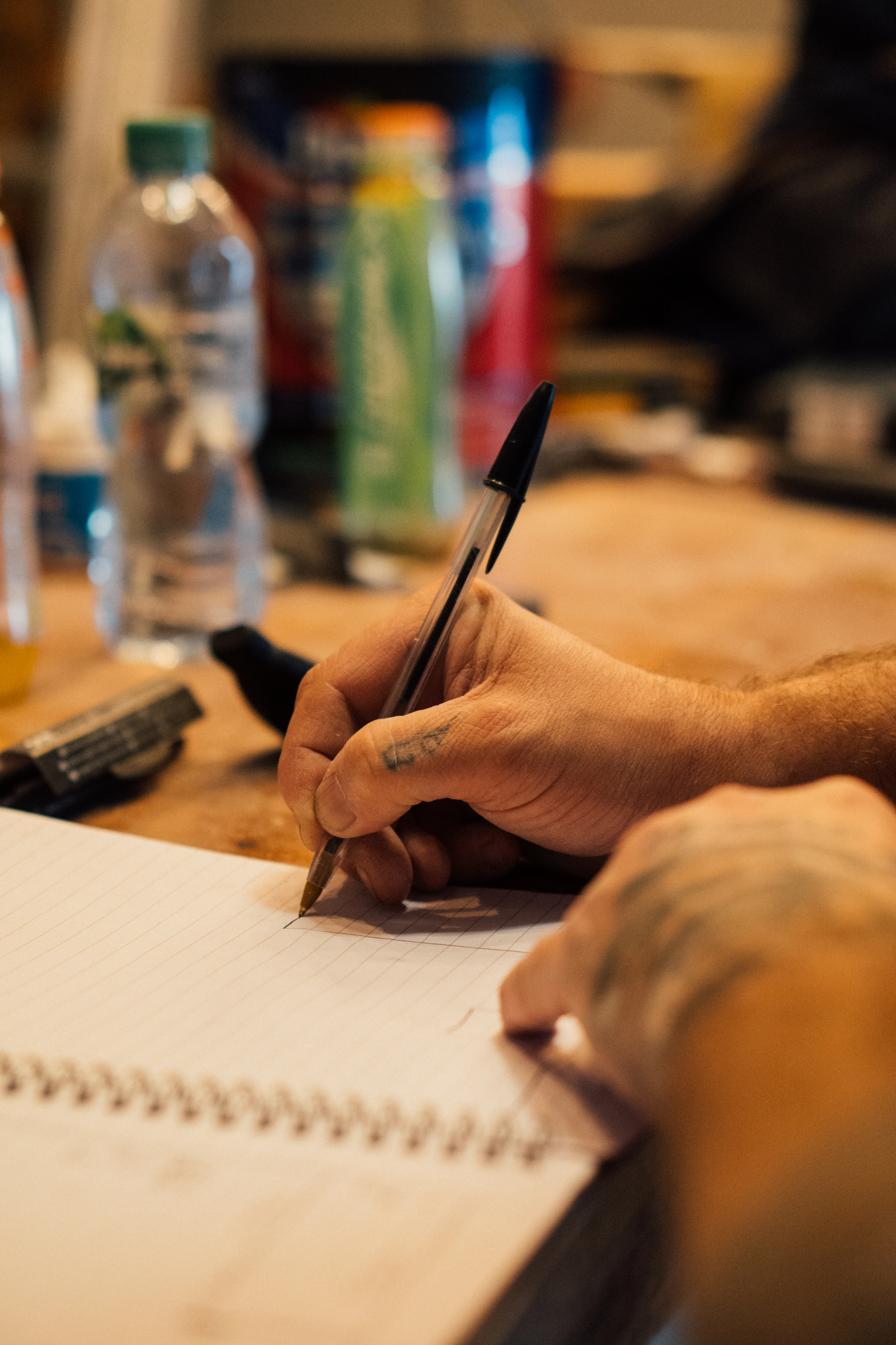 a person writing on a piece of paper