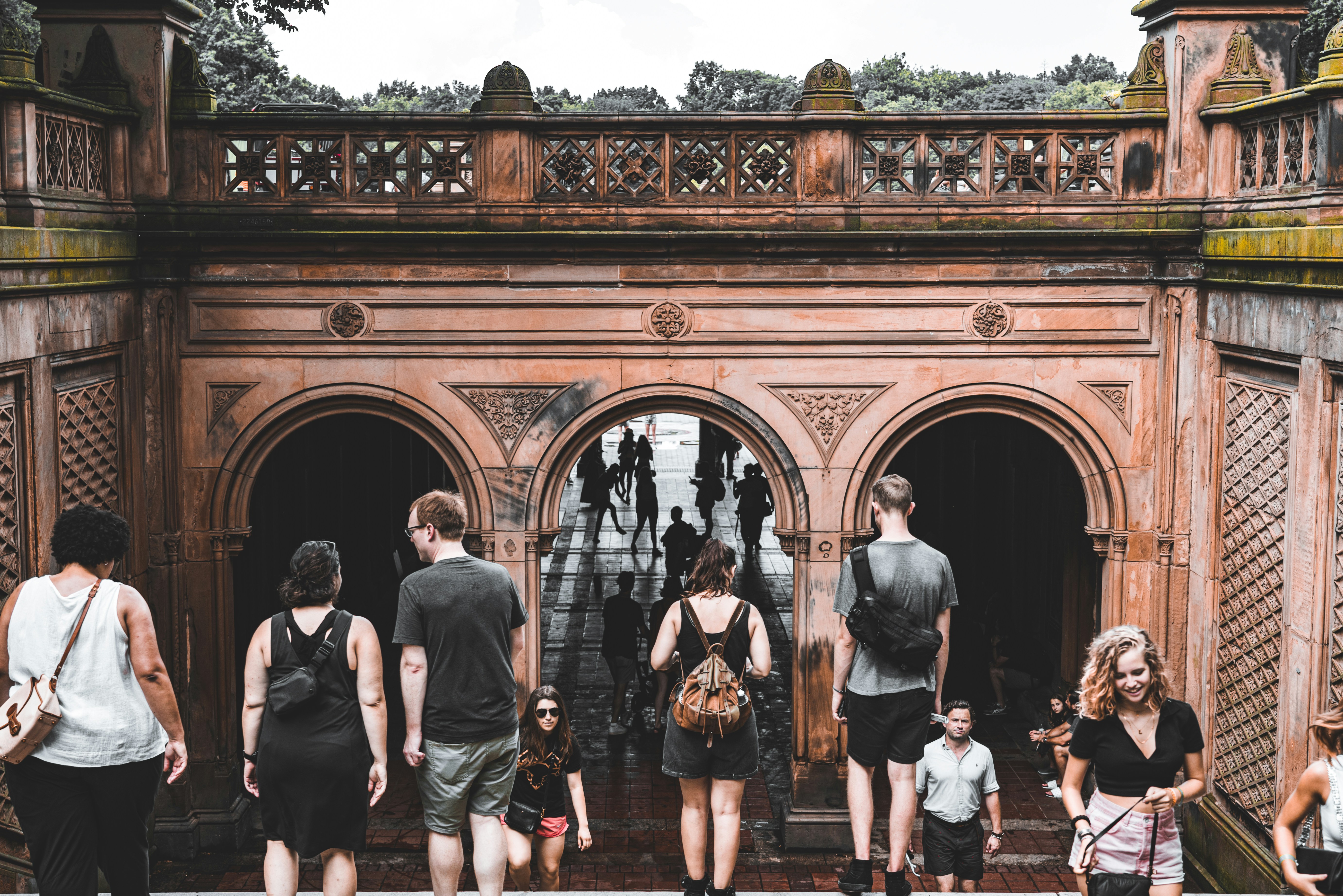 a group of people walking through a gate