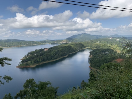 a river with trees and hills around it