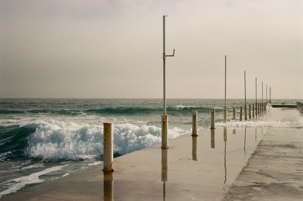 a dock with waves crashing on it