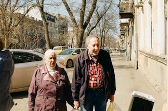 a group of people standing on a sidewalk