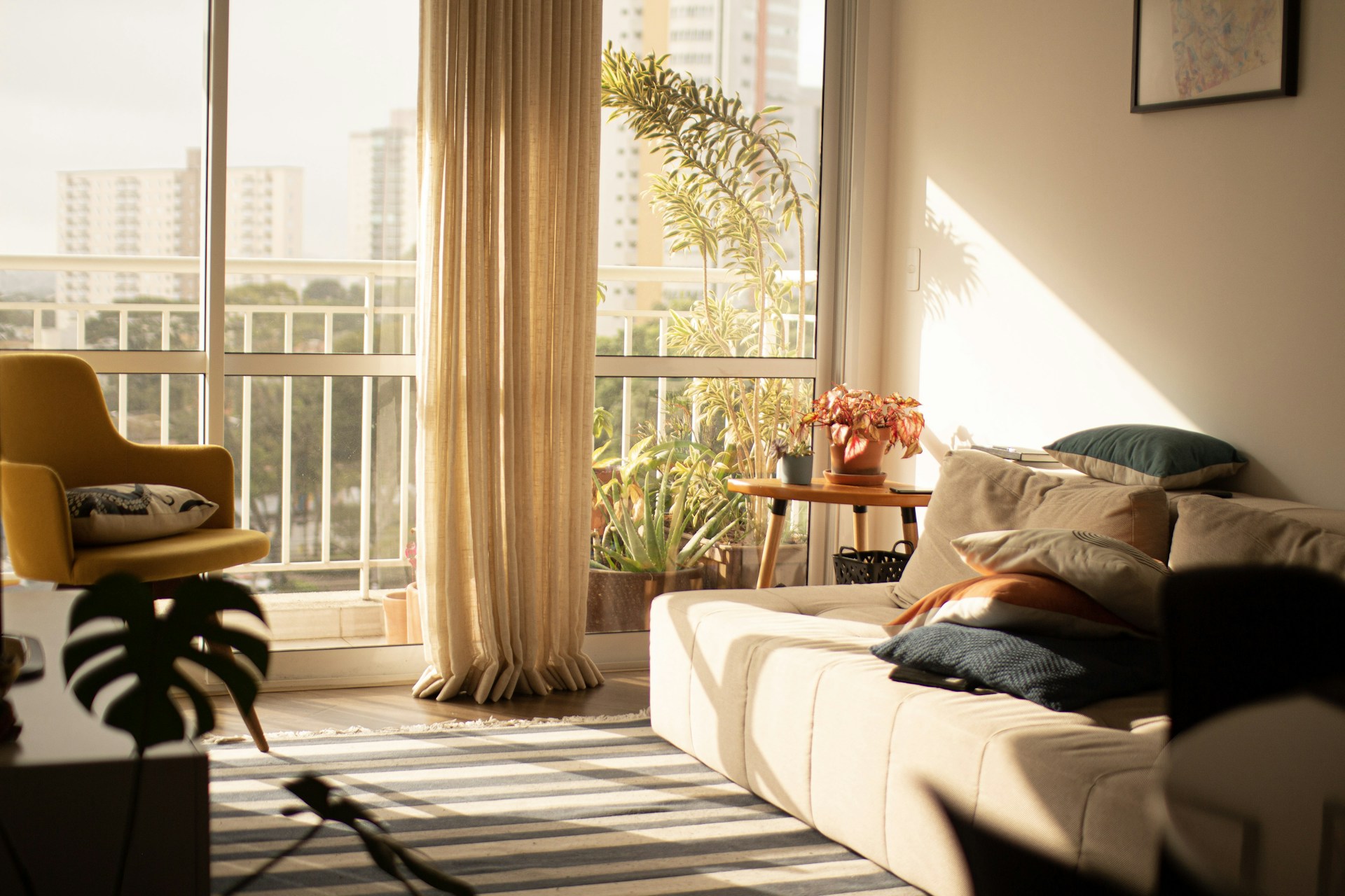 A serene living room with a cozy sofa and a large window letting in natural light.