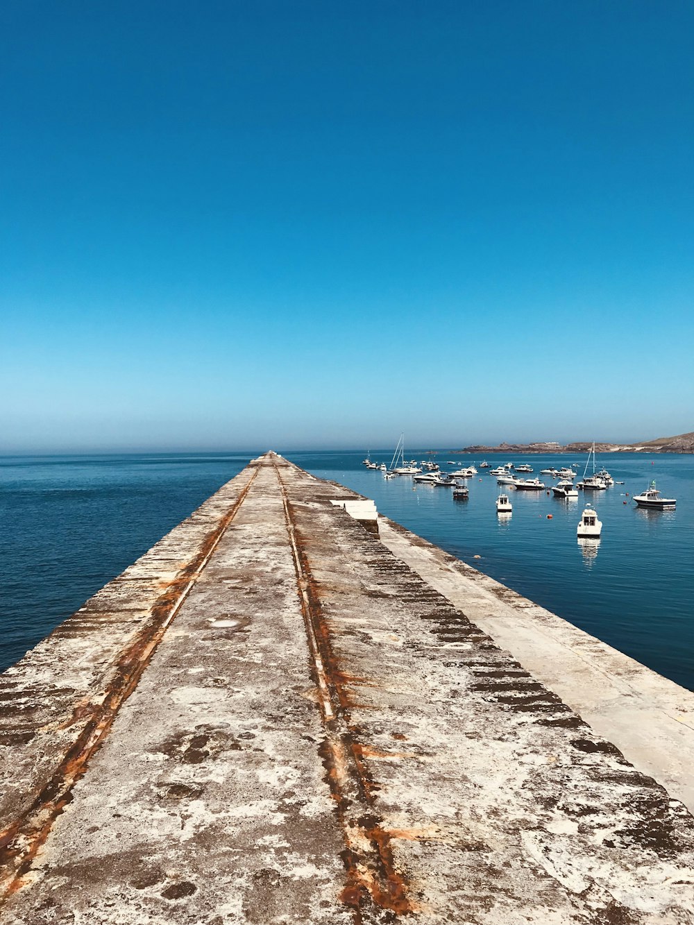 a dock with boats in the water