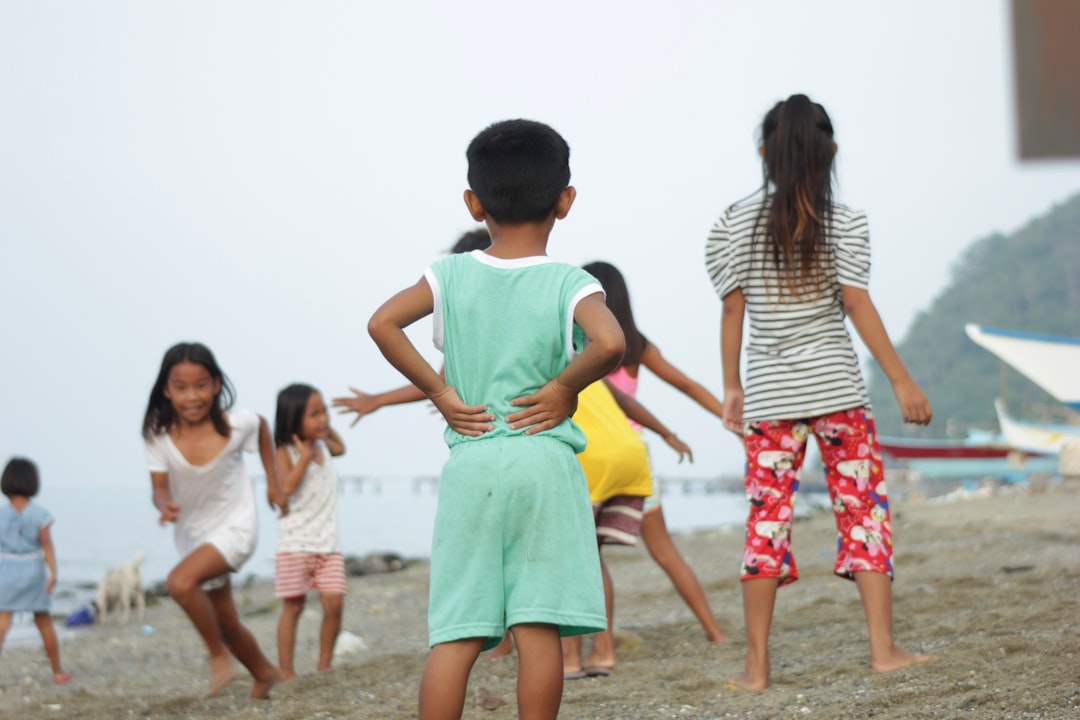 a group of children walking on a beach, Childhood memories