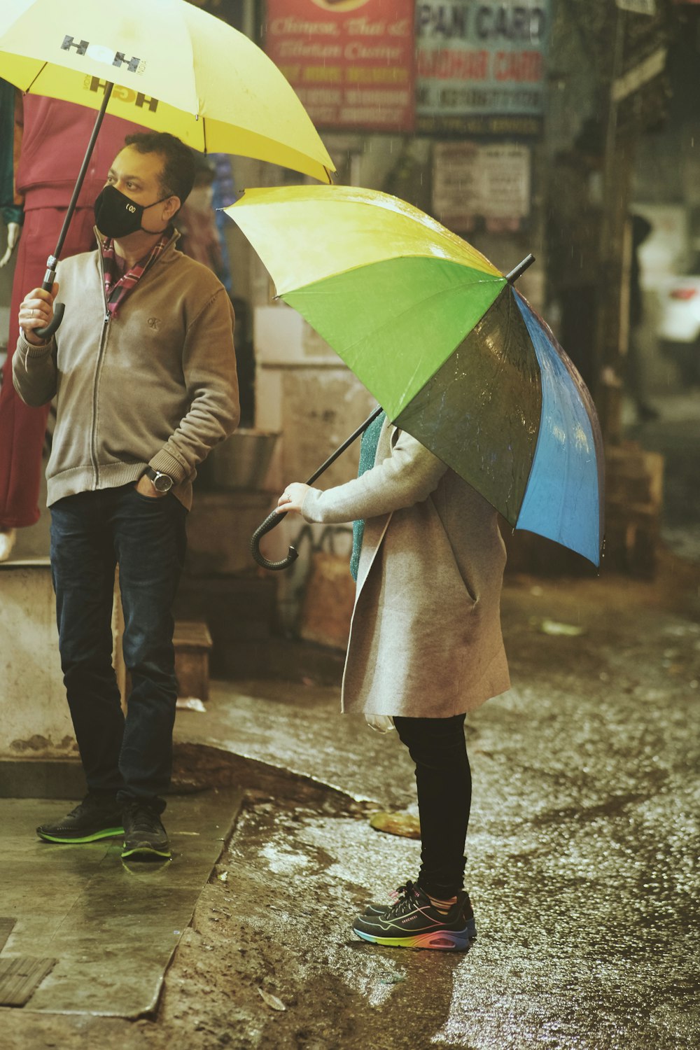 a person walking in the rain holding an umbrella